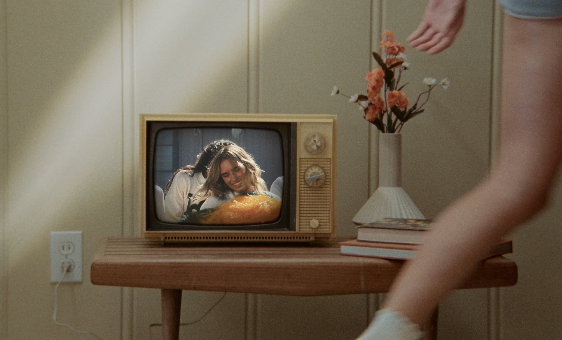 A vintage television on a wooden table playing the series Beverly Heights